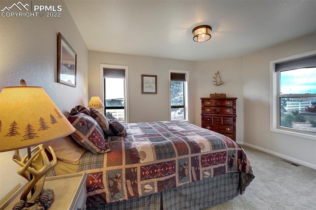 30905 Ridge Road Ramah, CO 80832 - Photo 14 of 36 a bedroom with a bed and wooden floor