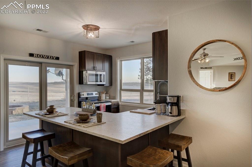 30905 Ridge Road Ramah, CO 80832 - Photo 22 of 36 a view of a dining room with furniture window and wooden floor