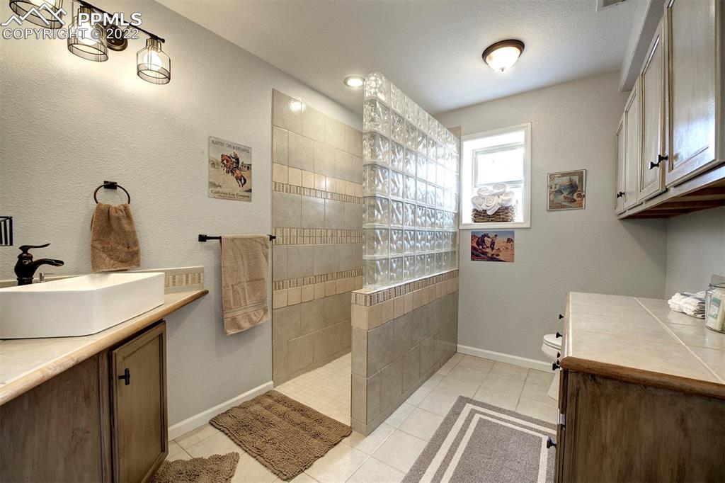 30905 Ridge Road Ramah, CO 80832 - Photo 25 of 36 a bathroom with a sink mirror and shower