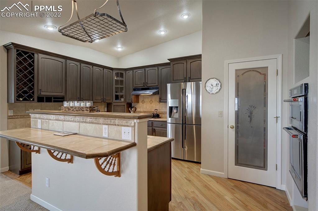 30905 Ridge Road Ramah, CO 80832 - Photo 5 of 36 a kitchen with kitchen island stainless steel appliances a sink stove and refrigerator