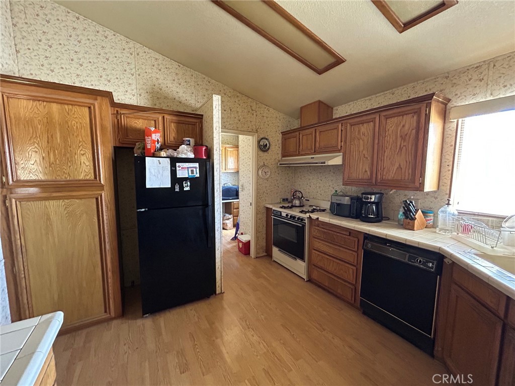 27250 Murrieta Road, Unit 347 Menifee, CA 92586 - Photo 11 of 39 a kitchen with stainless steel appliances granite countertop a refrigerator and a sink