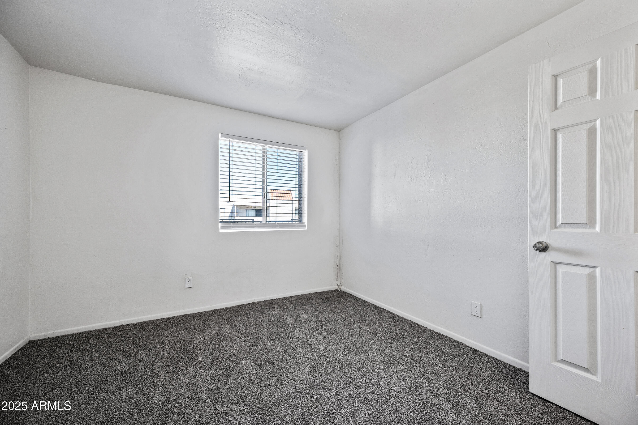 16602 North 25th Street, Unit 212 Phoenix, AZ 85032 - Photo 15 of 16 an empty room with a window