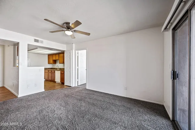 a view of a kitchen with a sink and a ceiling fan