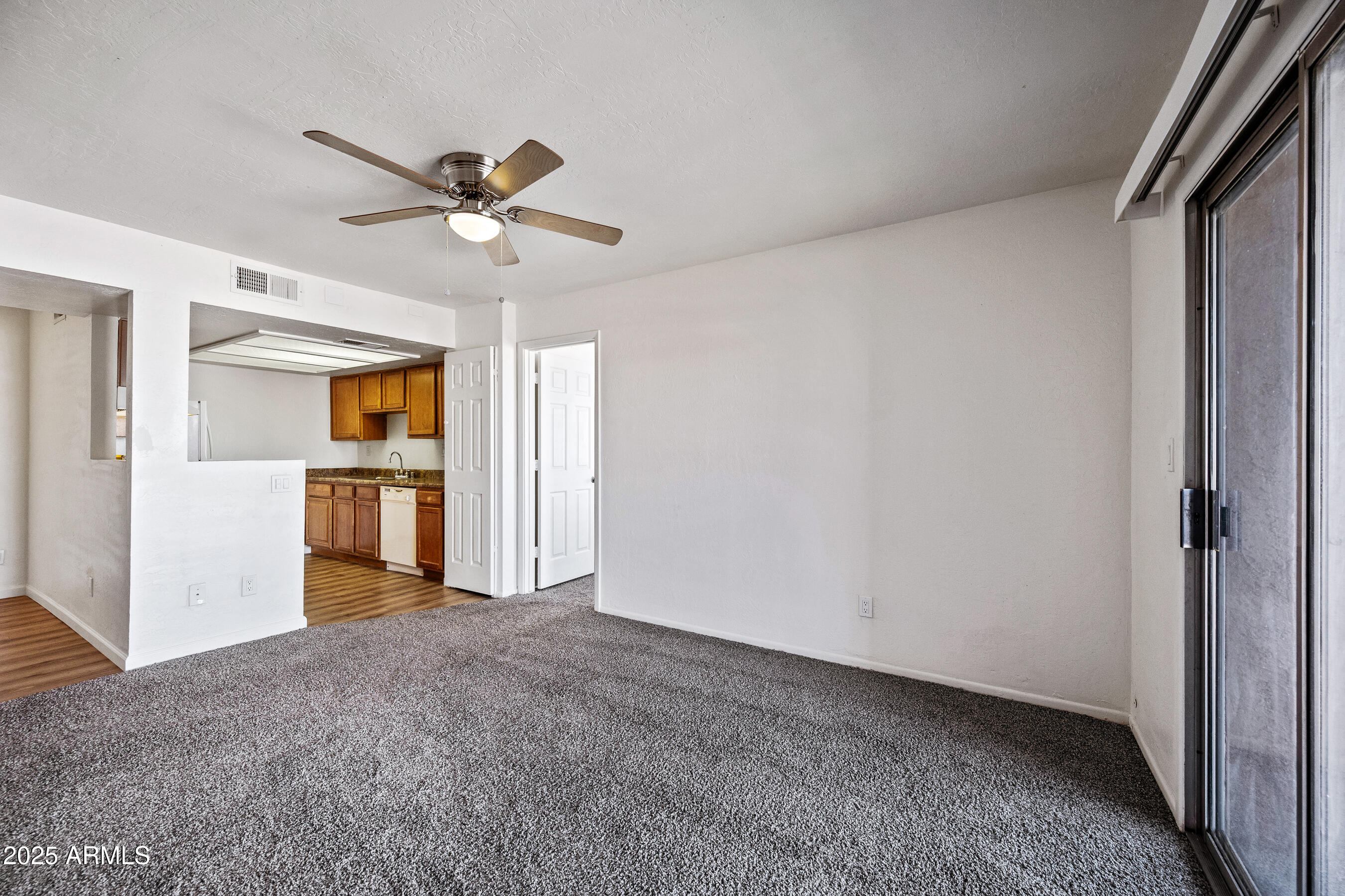 16602 North 25th Street, Unit 212 Phoenix, AZ 85032 - Photo 3 of 16 a view of a kitchen with a sink and a ceiling fan