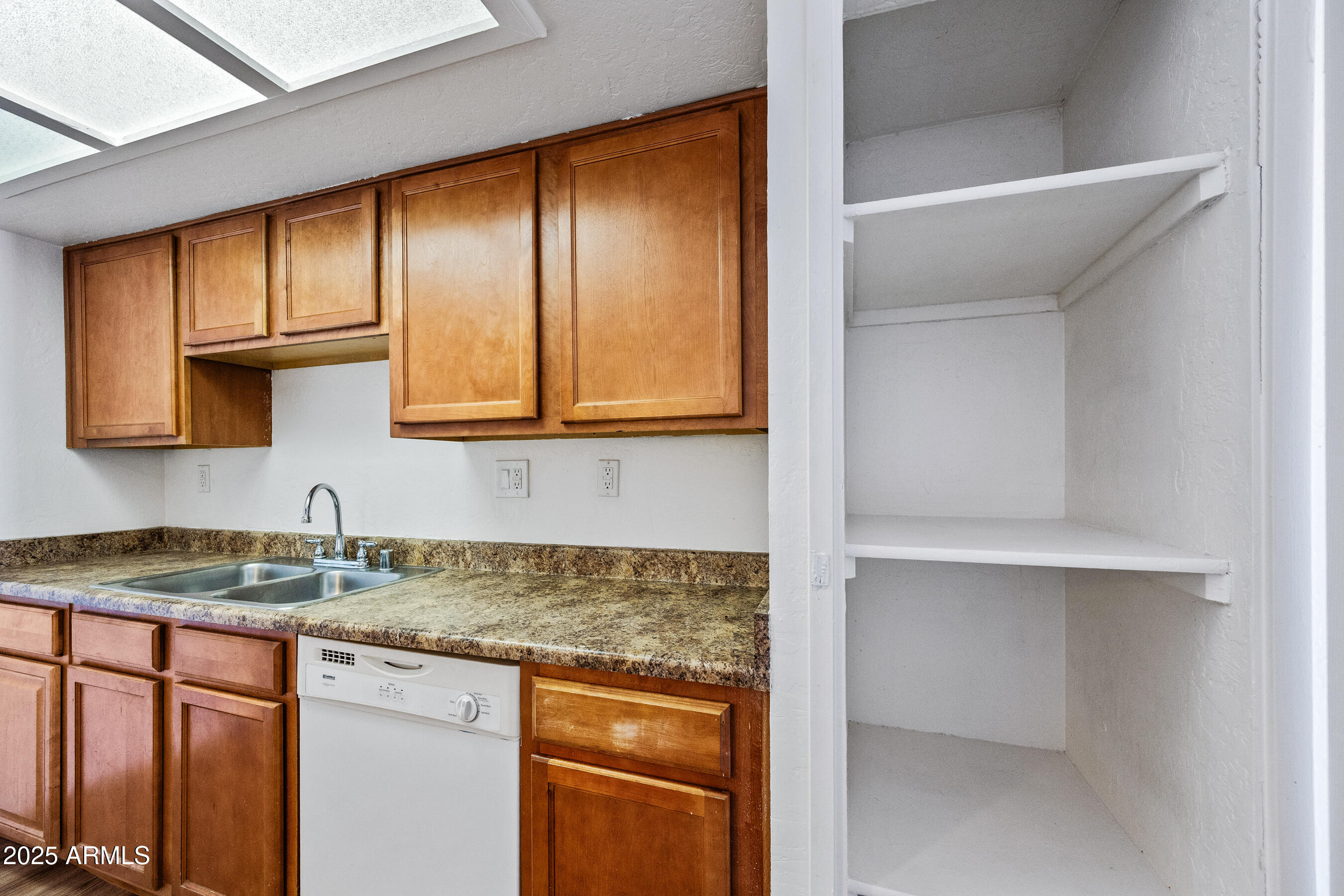 16602 North 25th Street, Unit 212 Phoenix, AZ 85032 - Photo 8 of 16 a kitchen with stainless steel appliances granite countertop cabinets and window