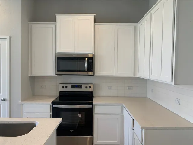 a kitchen with a sink and a stove top oven