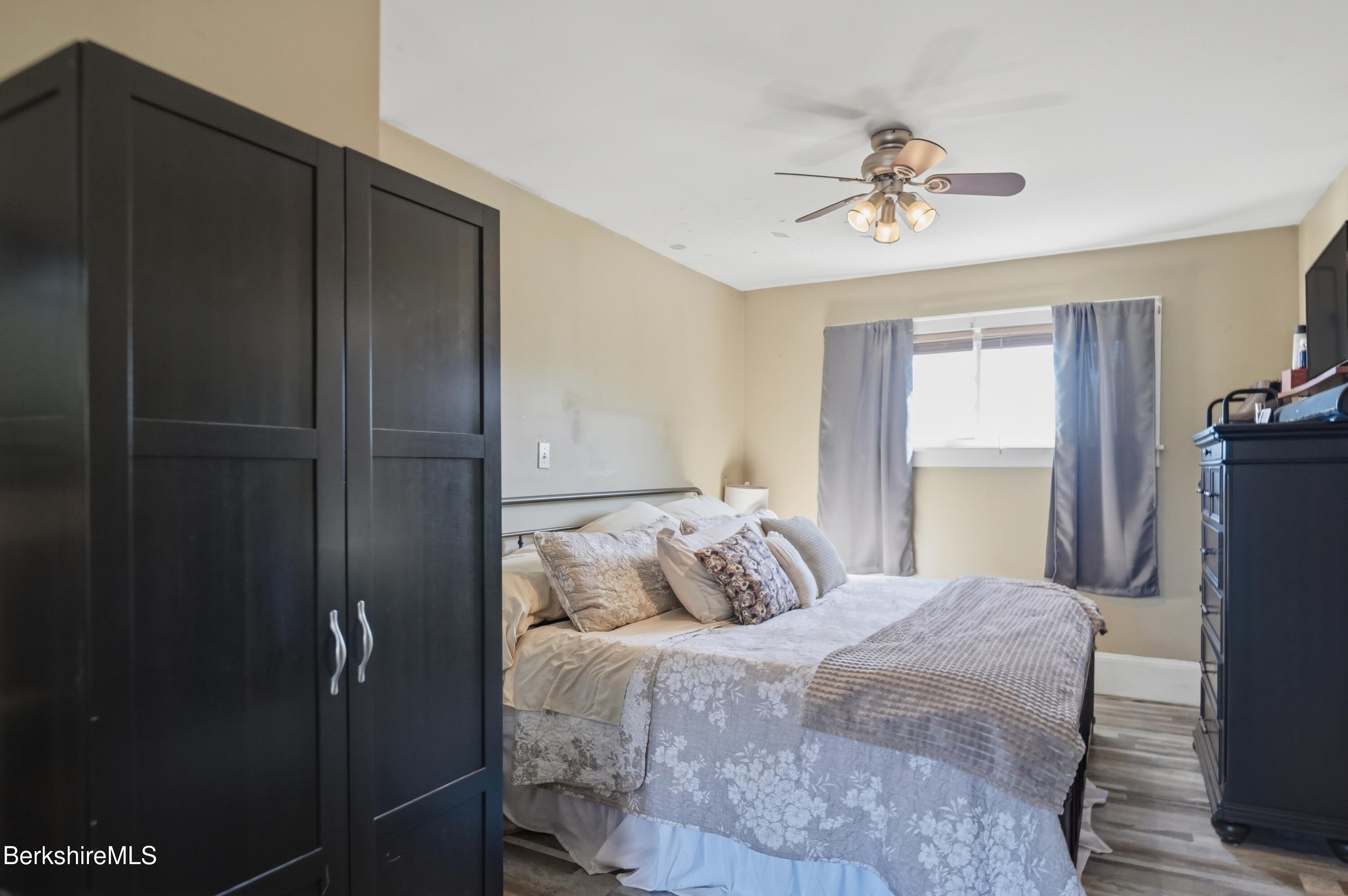 22 Broadway Street Pittsfield, MA 01201 - Photo 66 of 84 a bedroom with a bed and a chandelier