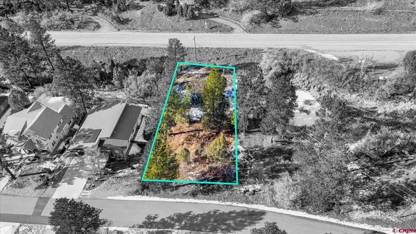 a view of a yard with wooden fence