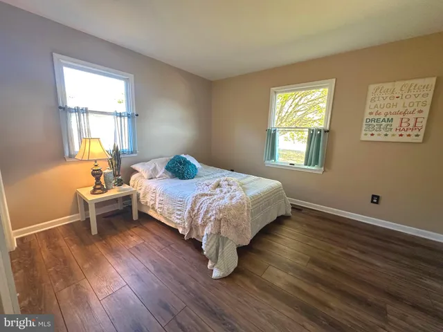 a spacious bathroom with a tub sink and mirror