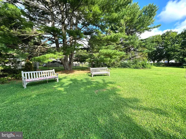 a front view of a house with a wooden bench