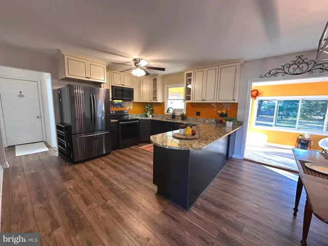 a living room with furniture windows and a kitchen view