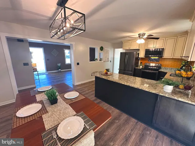 a living room with furniture a dining table and chairs