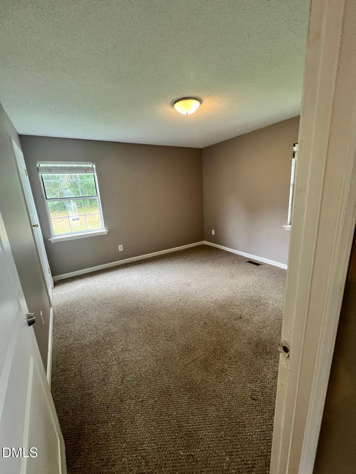 1111 Penzance Avenue Durham, NC 27704 - Photo 12 of 18 an empty room with windows