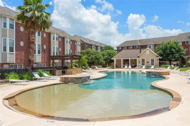 a view of a house with swimming pool and sitting area