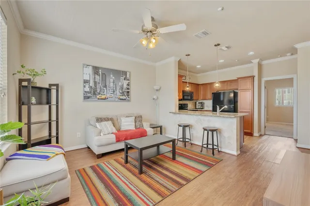 a living room with furniture and kitchen view