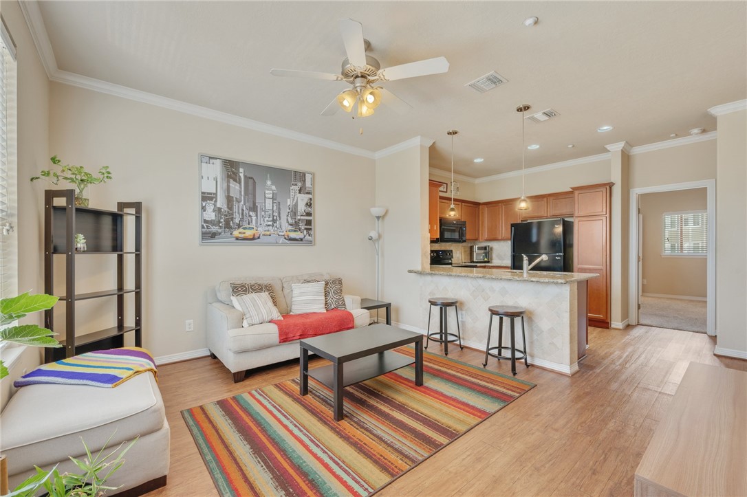 1198 Jones-Butler Road, Unit 3110 College Station, TX 77840 - Photo 3 of 16 a living room with furniture and kitchen view