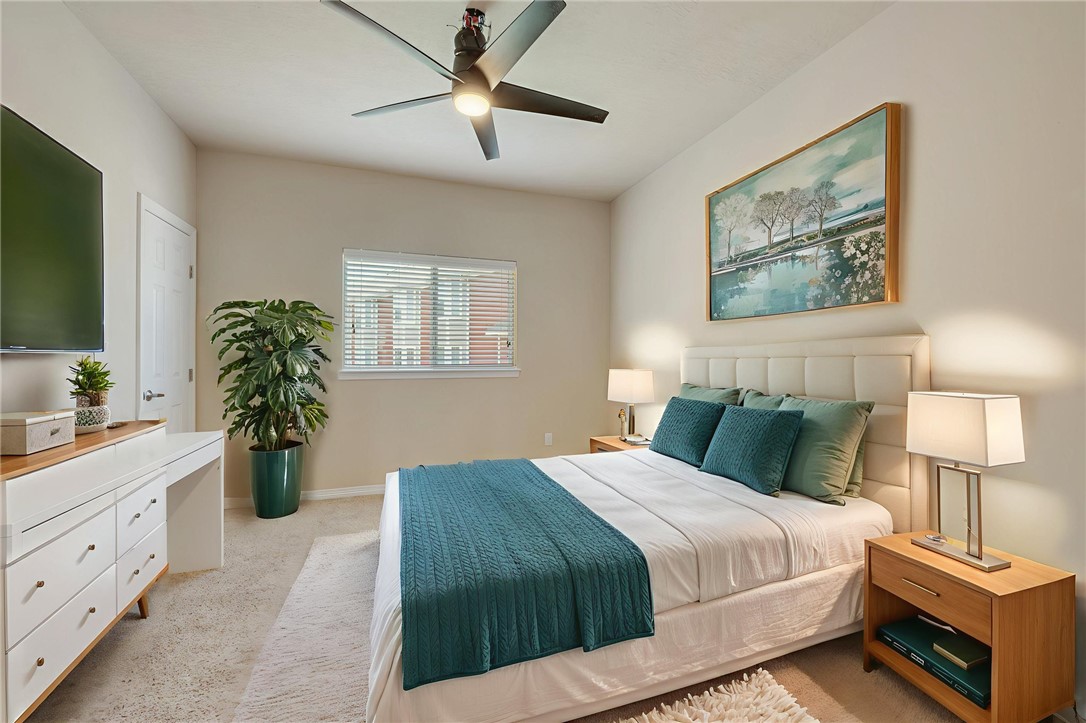 1198 Jones-Butler Road, Unit 3110 College Station, TX 77840 - Photo 7 of 16 a bedroom with a large bed and a flat tv screen on dresser