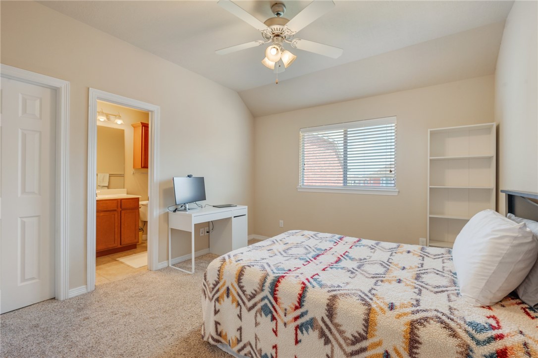 1198 Jones-Butler Road, Unit 3110 College Station, TX 77840 - Photo 9 of 16 a bedroom with a bed and a chandelier