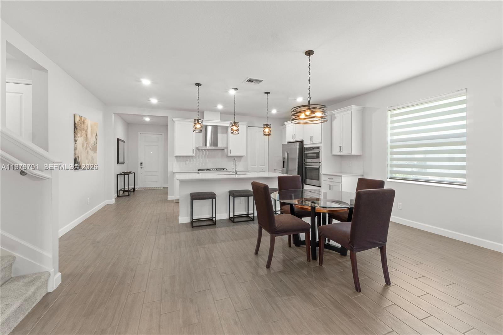 1162 Haywagon Trail Loxahatchee, FL 33470 - Photo 11 of 50 a dining room with furniture and window
