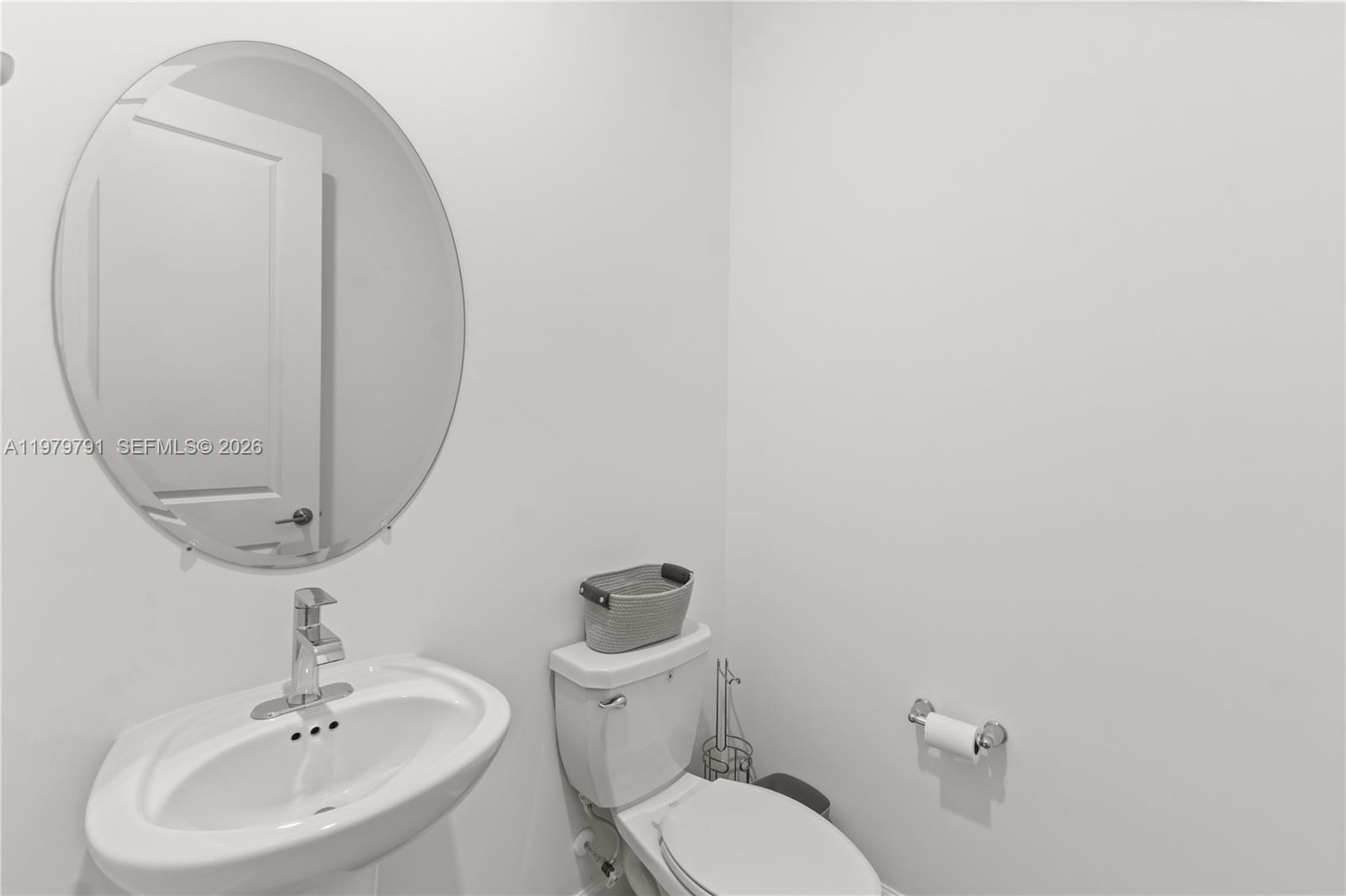 1162 Haywagon Trail Loxahatchee, FL 33470 - Photo 16 of 50 a bathroom with a toilet sink and mirror