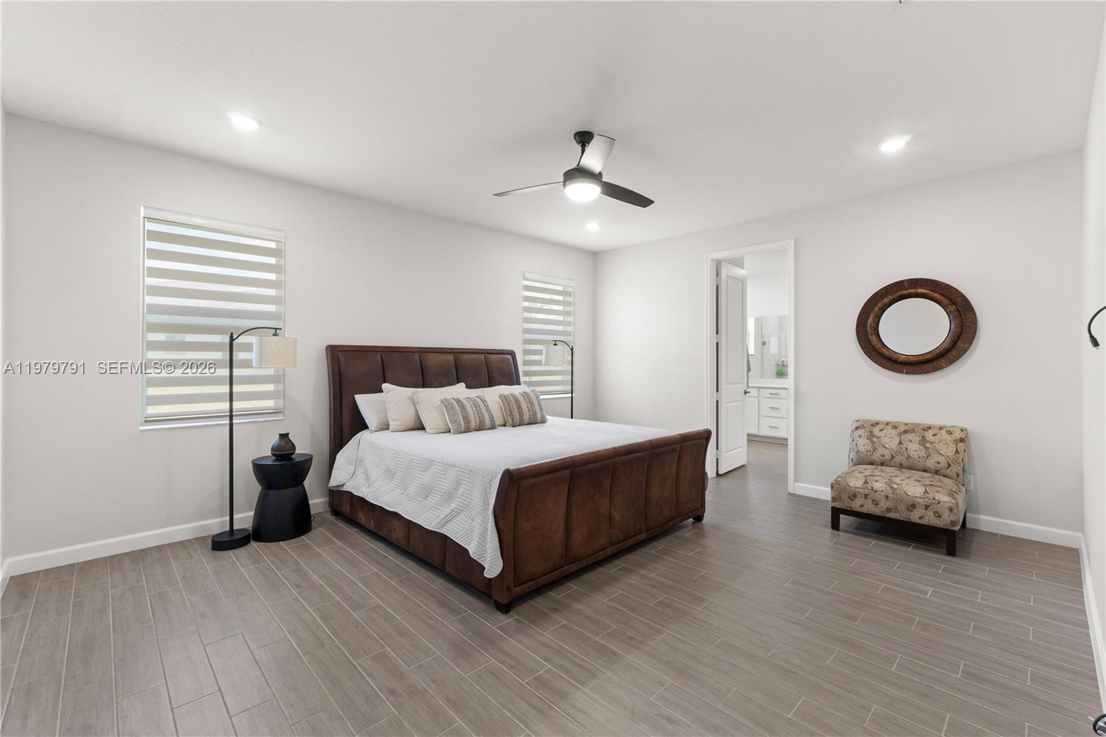 1162 Haywagon Trail Loxahatchee, FL 33470 - Photo 22 of 50 a bedroom with a bed and a chandelier