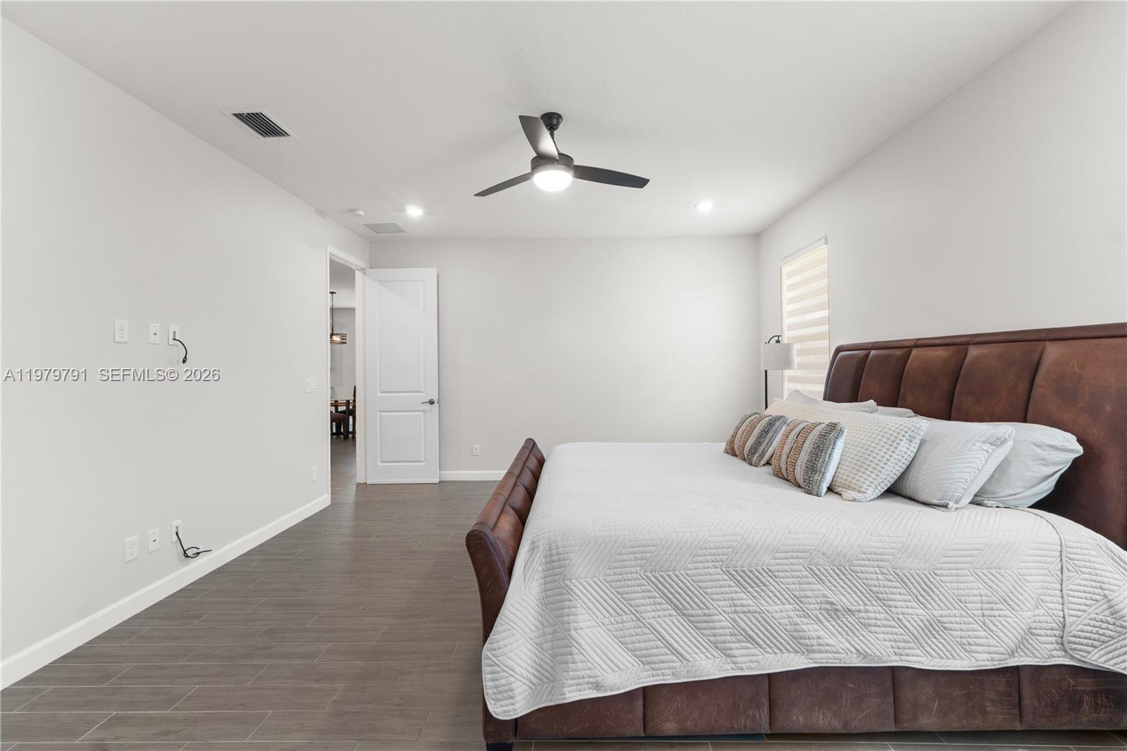 1162 Haywagon Trail Loxahatchee, FL 33470 - Photo 23 of 50 a bedroom with a bed and ceiling fan