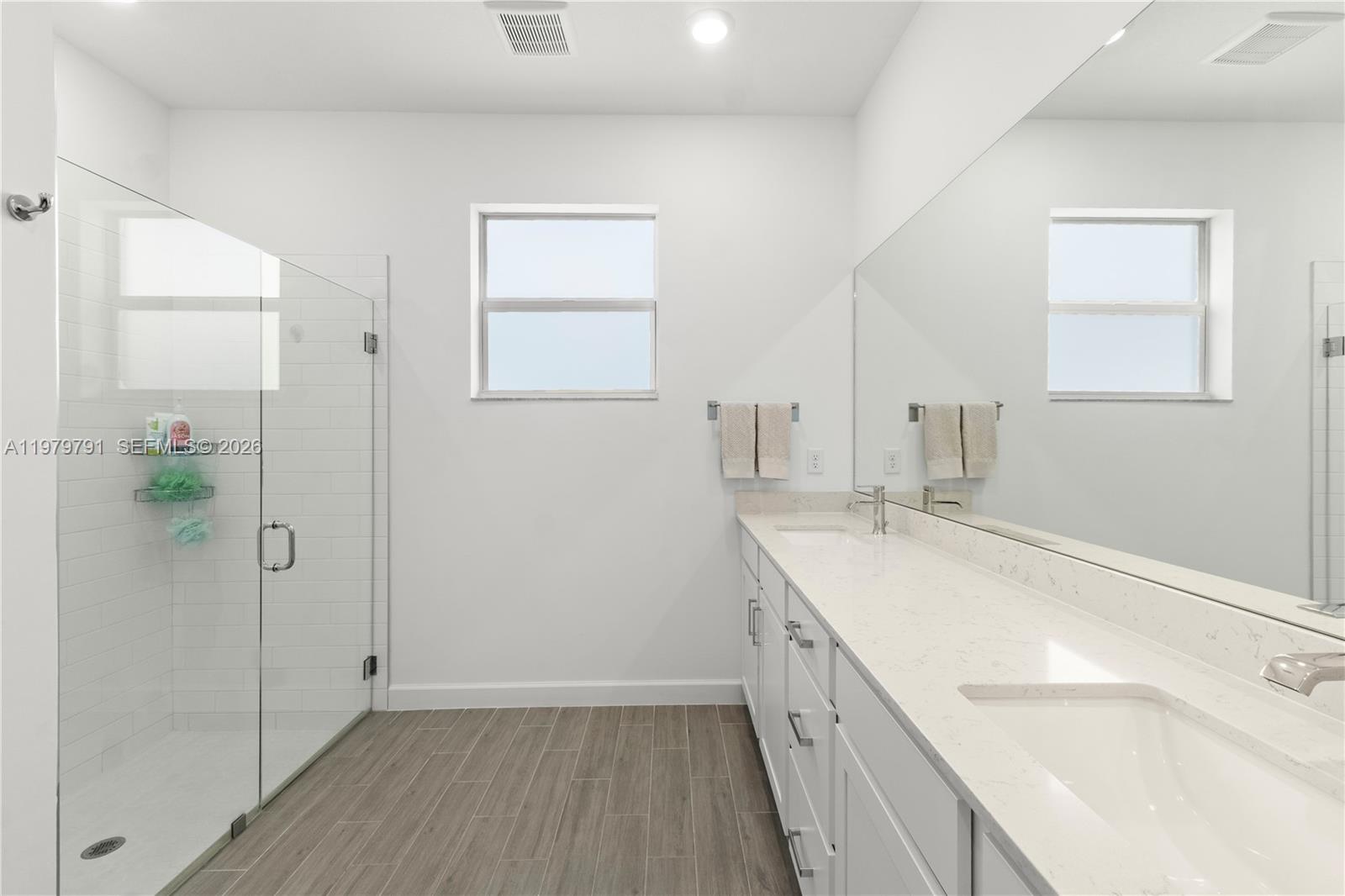 1162 Haywagon Trail Loxahatchee, FL 33470 - Photo 24 of 50 a bathroom with a sink a mirror and a shower