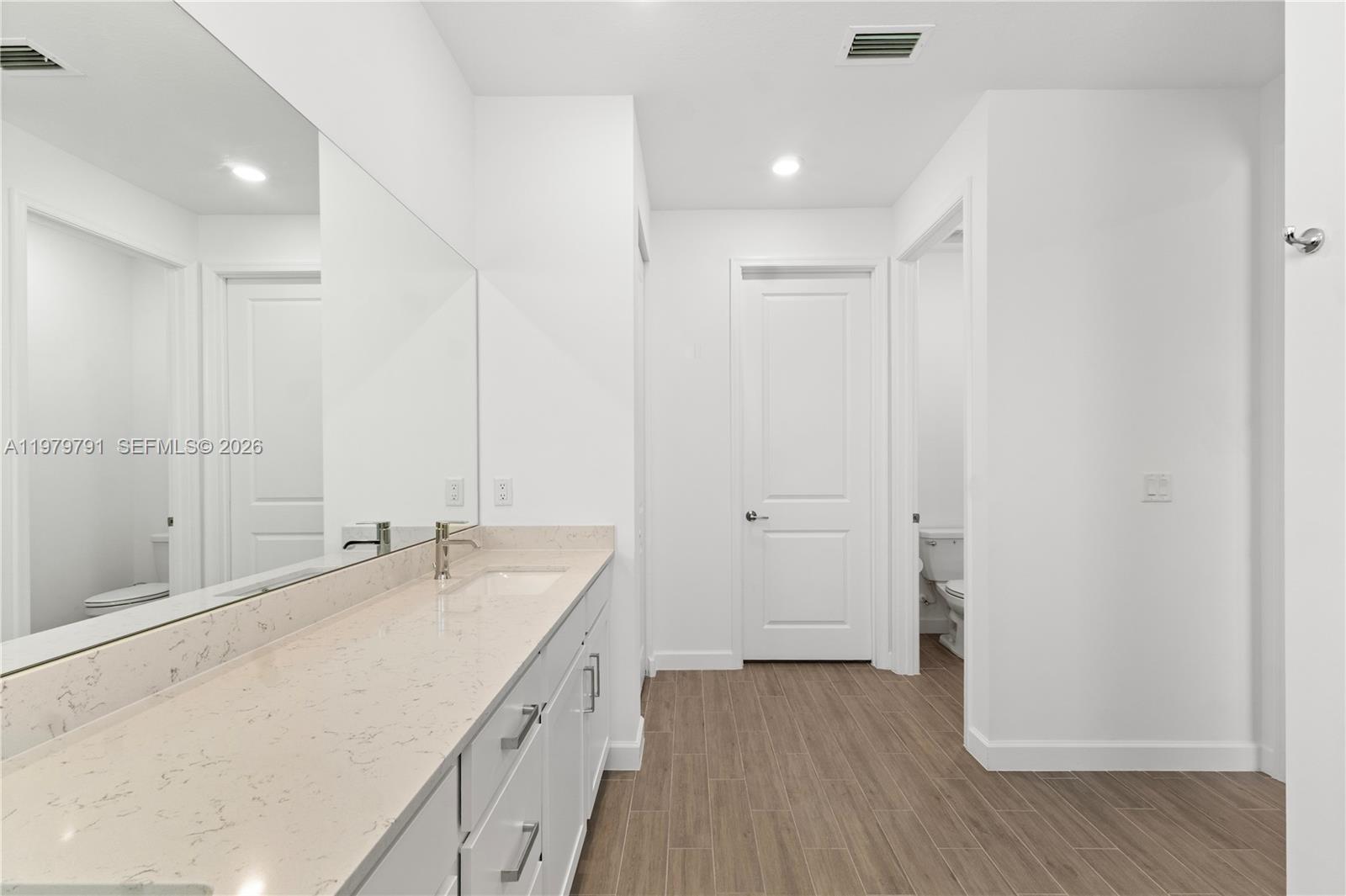 1162 Haywagon Trail Loxahatchee, FL 33470 - Photo 28 of 50 a spacious bathroom with a double vanity sink and a mirror