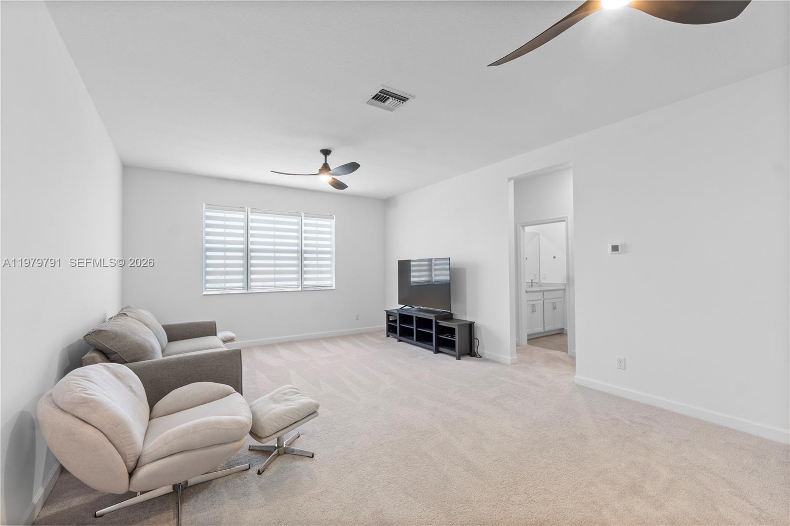 1162 Haywagon Trail Loxahatchee, FL 33470 - Photo 29 of 50 a living room with furniture and a flat screen tv