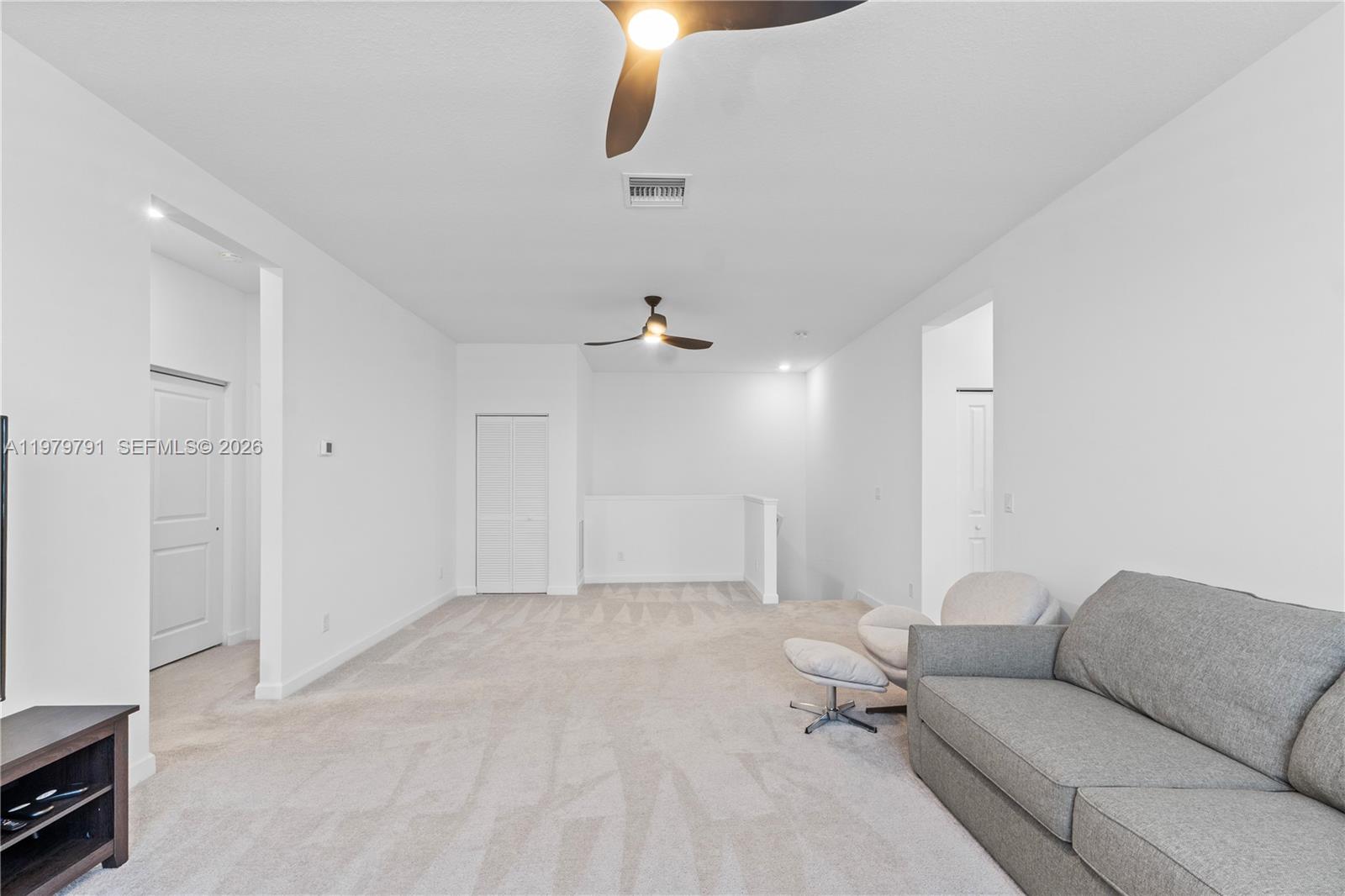 1162 Haywagon Trail Loxahatchee, FL 33470 - Photo 30 of 50 a living room with furniture and a ceiling fan