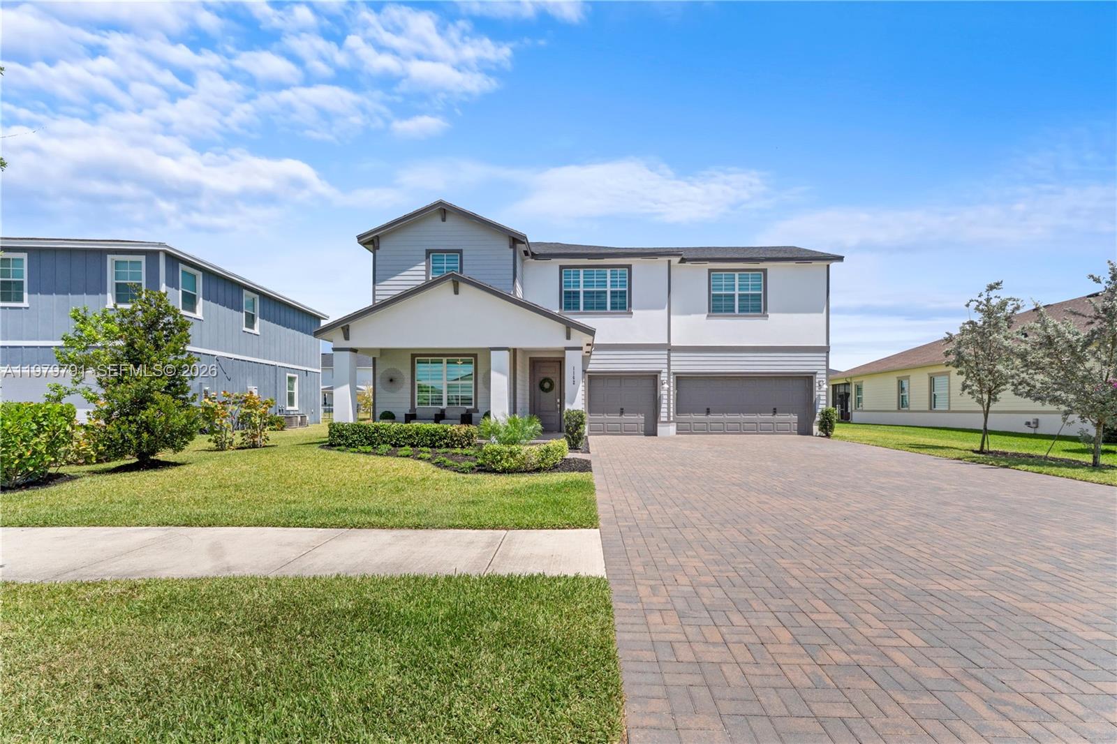 1162 Haywagon Trail Loxahatchee, FL 33470 - Photo 4 of 50 a front view of a house with a yard and garage