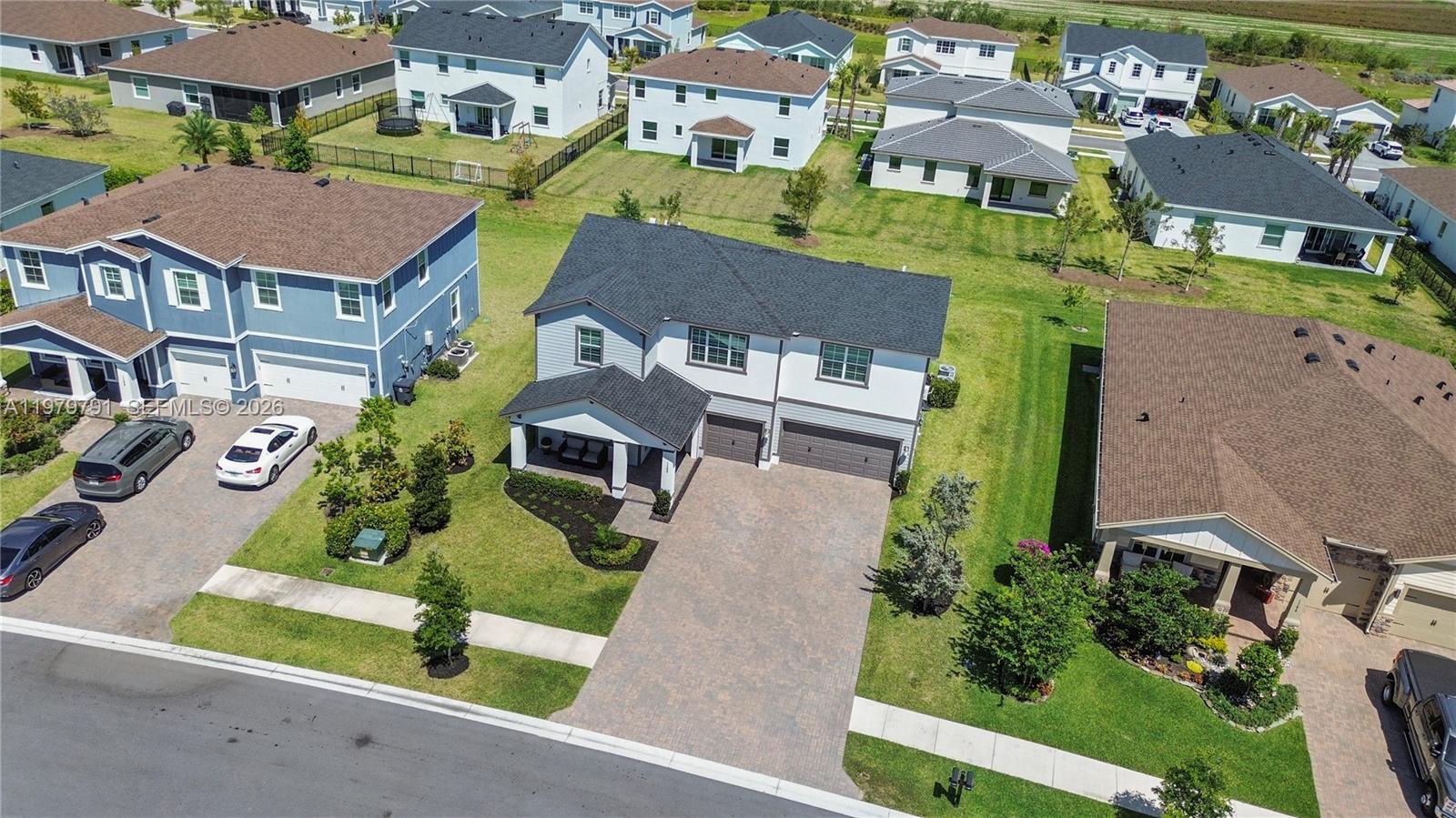1162 Haywagon Trail Loxahatchee, FL 33470 - Photo 41 of 50 an aerial view of multiple houses with a yard