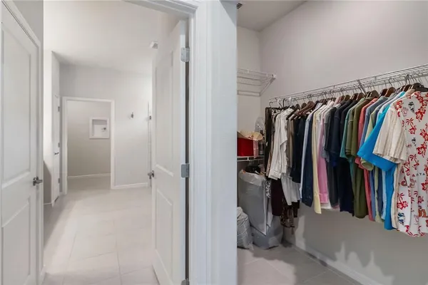 a view of walk in closet with clothes
