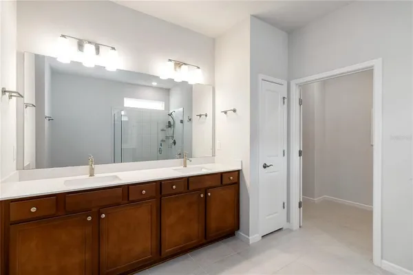 a bathroom with a double vanity sink mirror and double