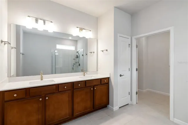a bathroom with a double vanity sink mirror and double