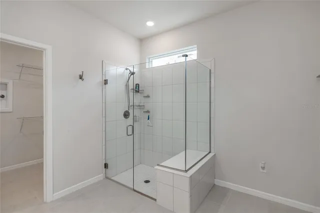 a bathroom with a shower and a glass door