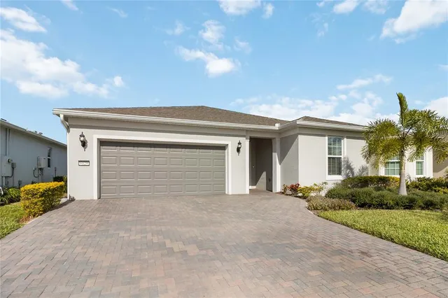 a view of house with garage and yard
