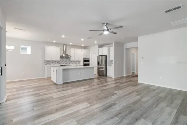 a view of a kitchen with a sink and a refrigerator