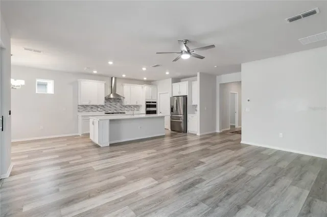 a view of a kitchen with a sink and a refrigerator