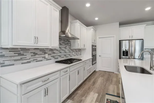 a kitchen with sink cabinets and stainless steel appliances