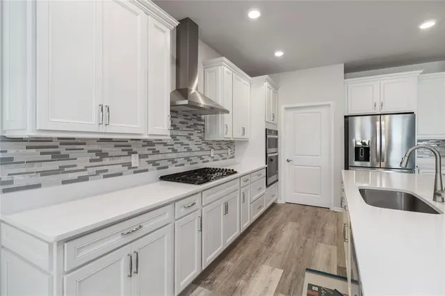 a kitchen with sink cabinets and stainless steel appliances