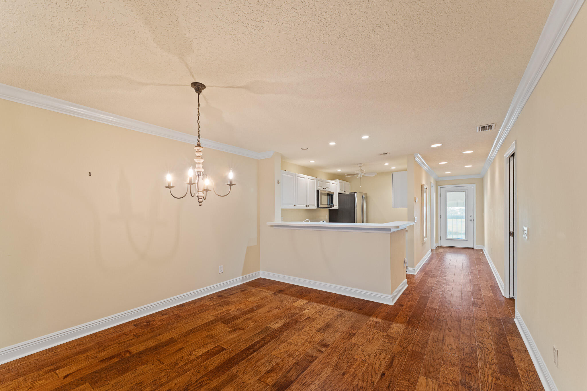 10 Northeast Plantation Road, Unit 305 Jensen Beach, FL 34957 - Photo 12 of 48 a view of a room with wooden floor and kitchen