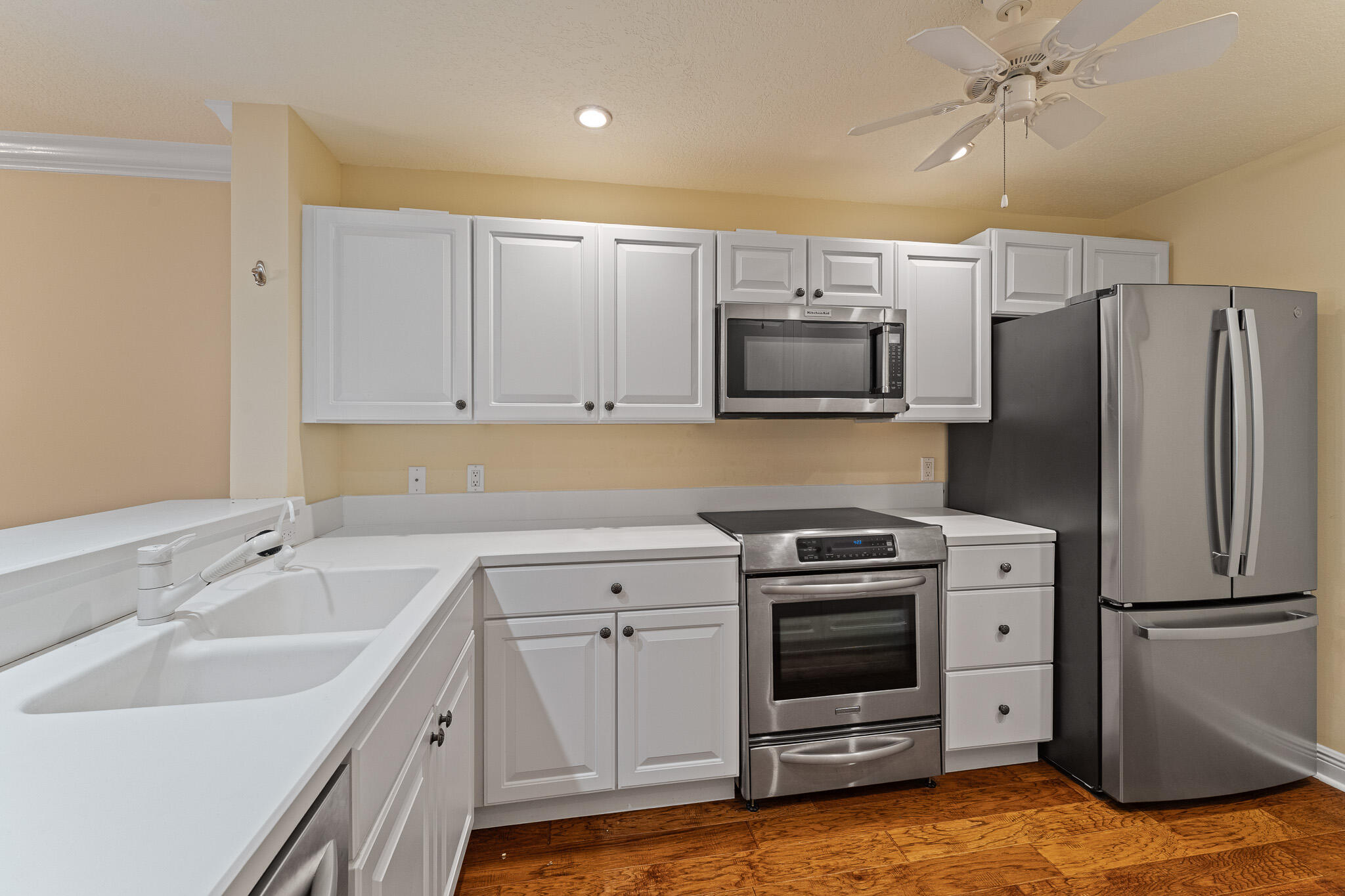 10 Northeast Plantation Road, Unit 305 Jensen Beach, FL 34957 - Photo 14 of 48 a kitchen with a sink appliances and cabinets