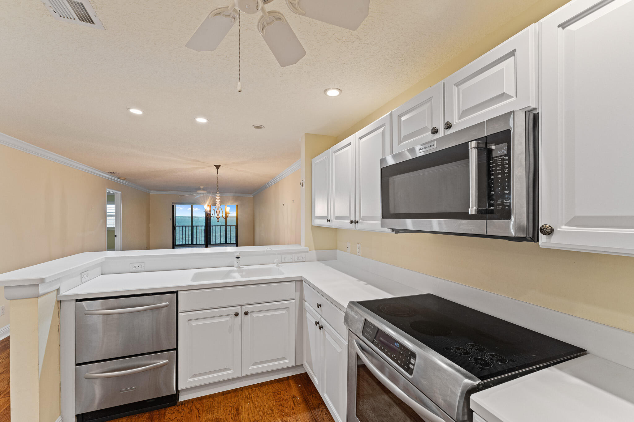 10 Northeast Plantation Road, Unit 305 Jensen Beach, FL 34957 - Photo 16 of 48 a kitchen with a sink stove and microwave