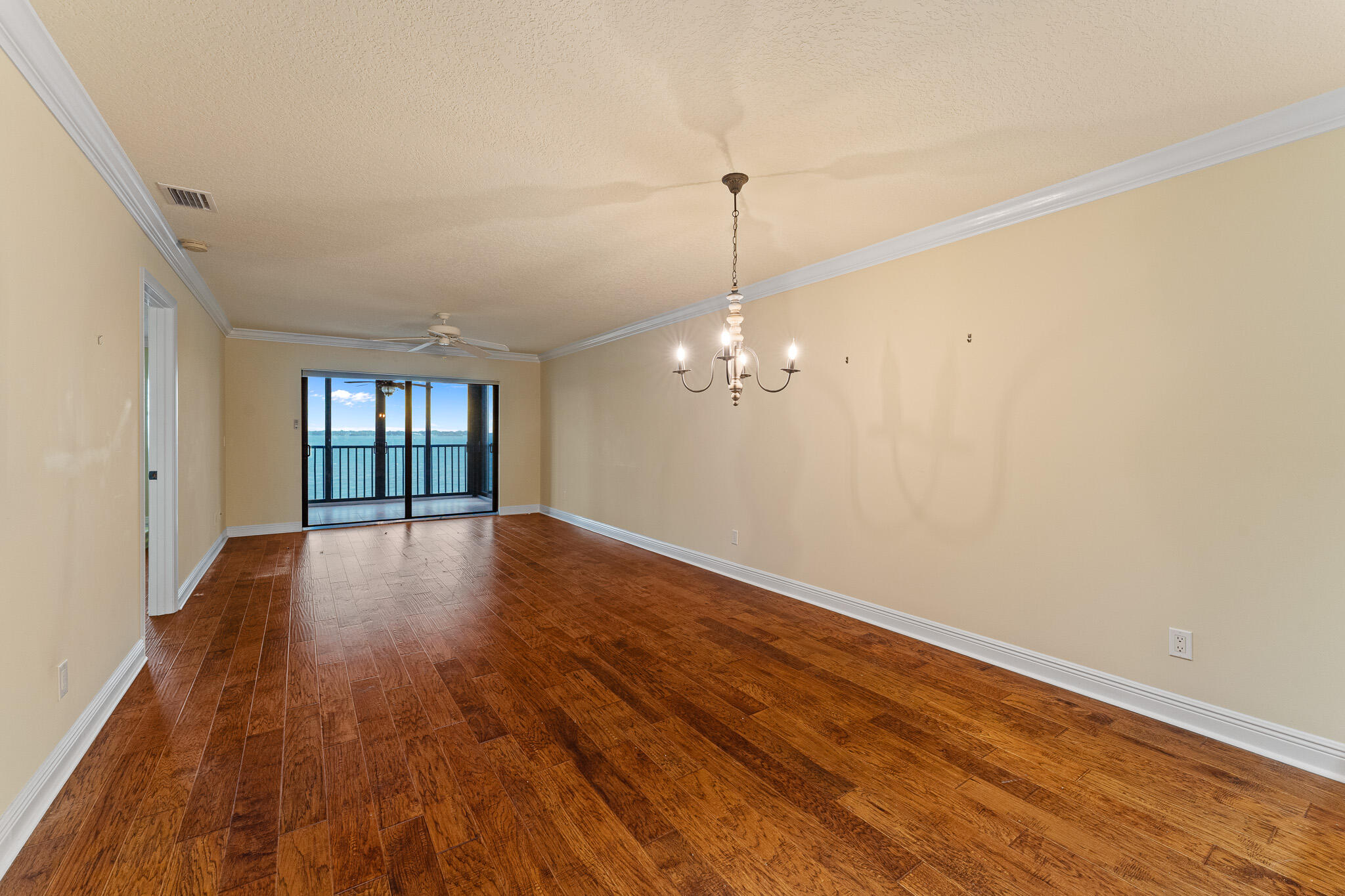 10 Northeast Plantation Road, Unit 305 Jensen Beach, FL 34957 - Photo 18 of 48 a view of empty room with wooden floor and fan