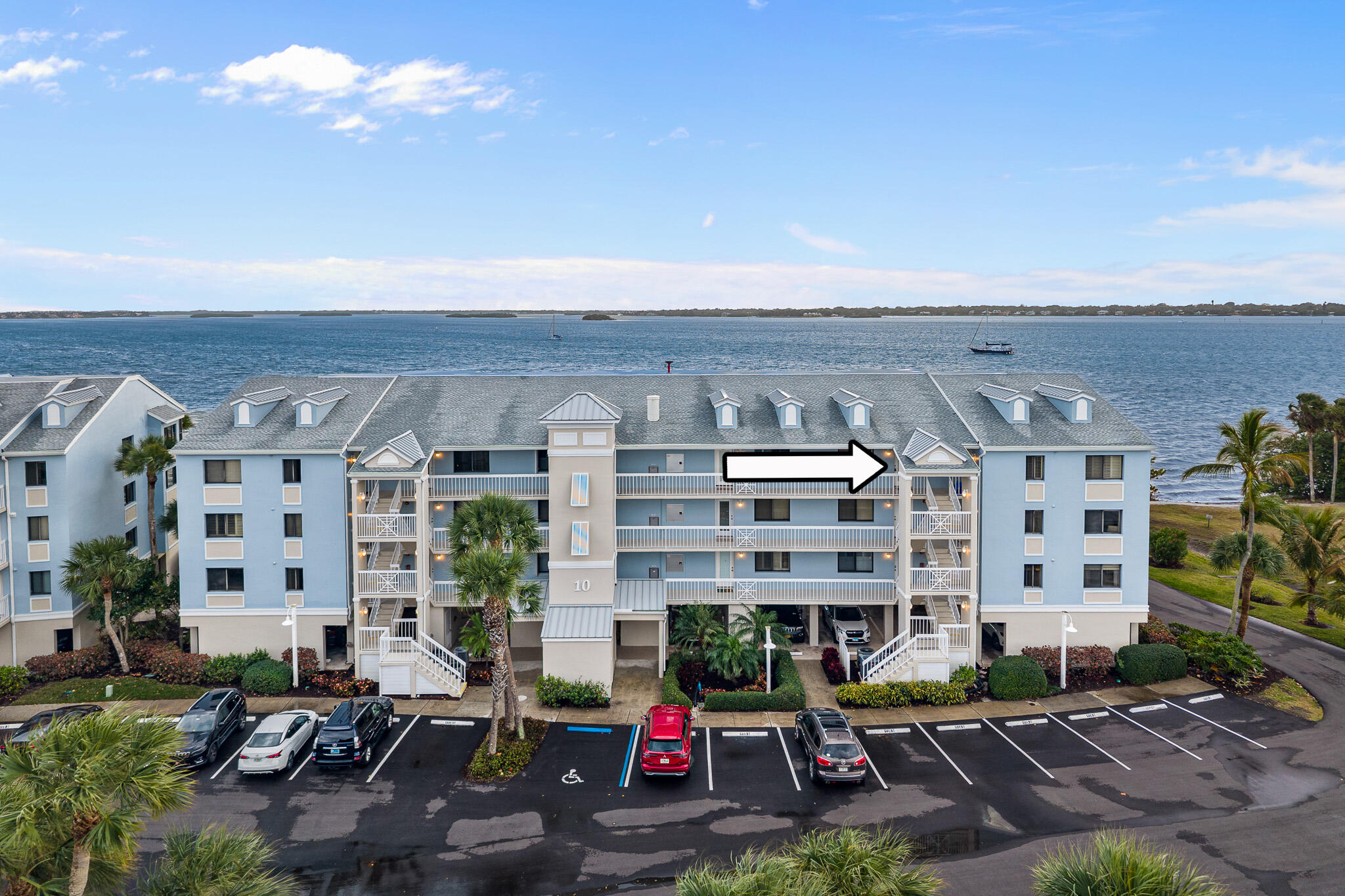 10 Northeast Plantation Road, Unit 305 Jensen Beach, FL 34957 - Photo 2 of 48 a view of building with outdoor space