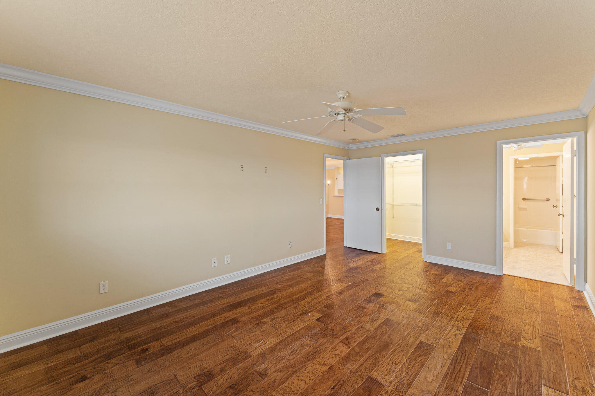 10 Northeast Plantation Road, Unit 305 Jensen Beach, FL 34957 - Photo 30 of 48 a view of an empty room and window with wooden floor