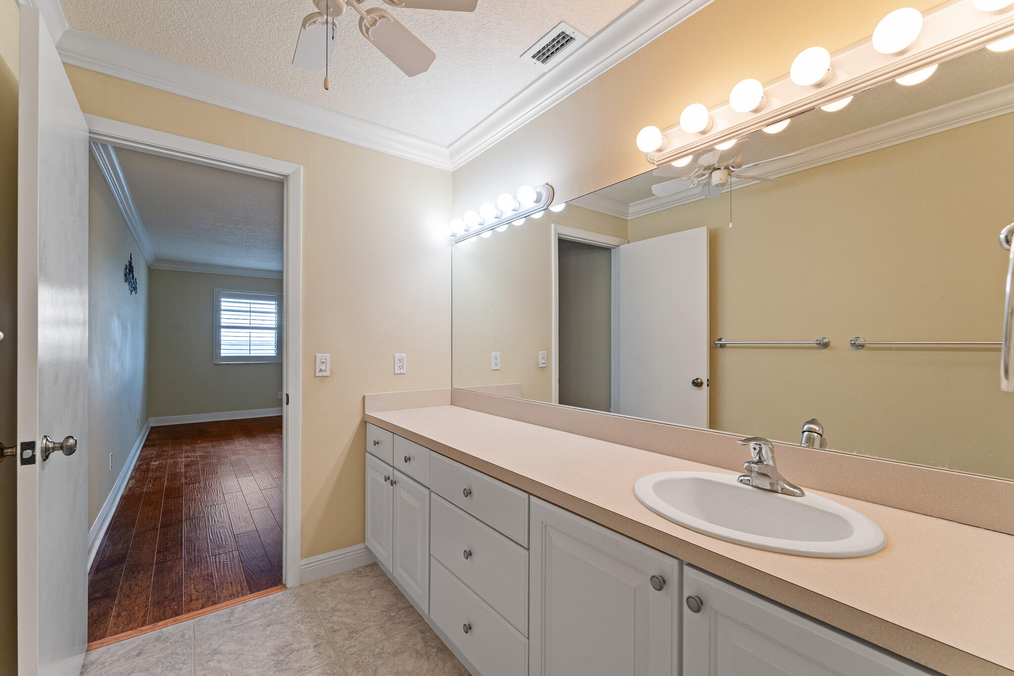 10 Northeast Plantation Road, Unit 305 Jensen Beach, FL 34957 - Photo 35 of 48 a bathroom with a double vanity sink and a mirror