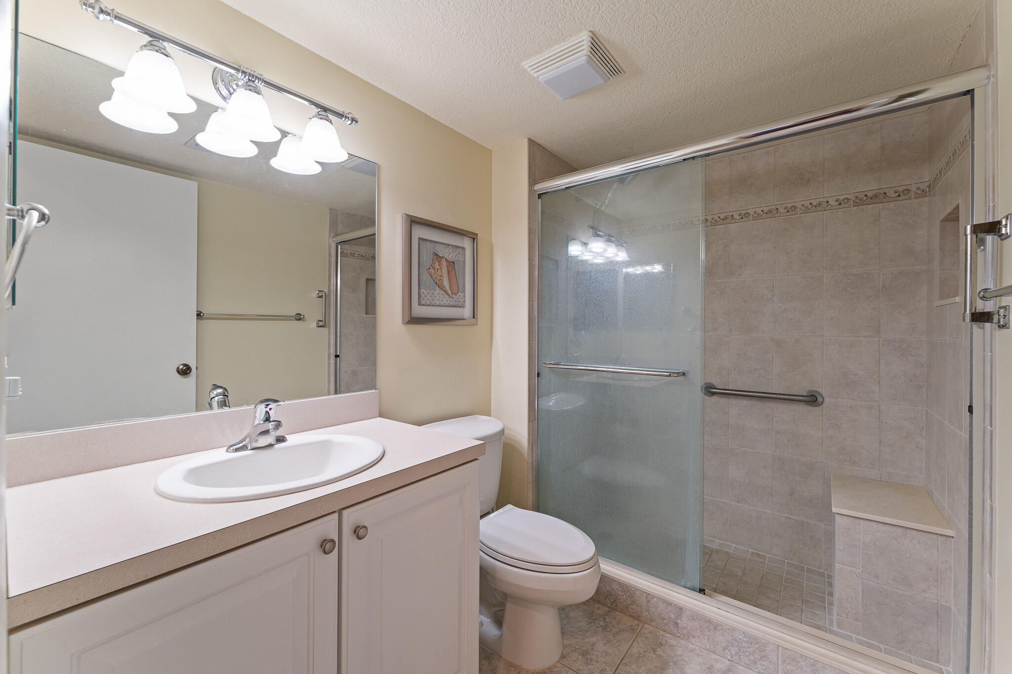 10 Northeast Plantation Road, Unit 305 Jensen Beach, FL 34957 - Photo 37 of 48 a bathroom with a sink a toilet and shower