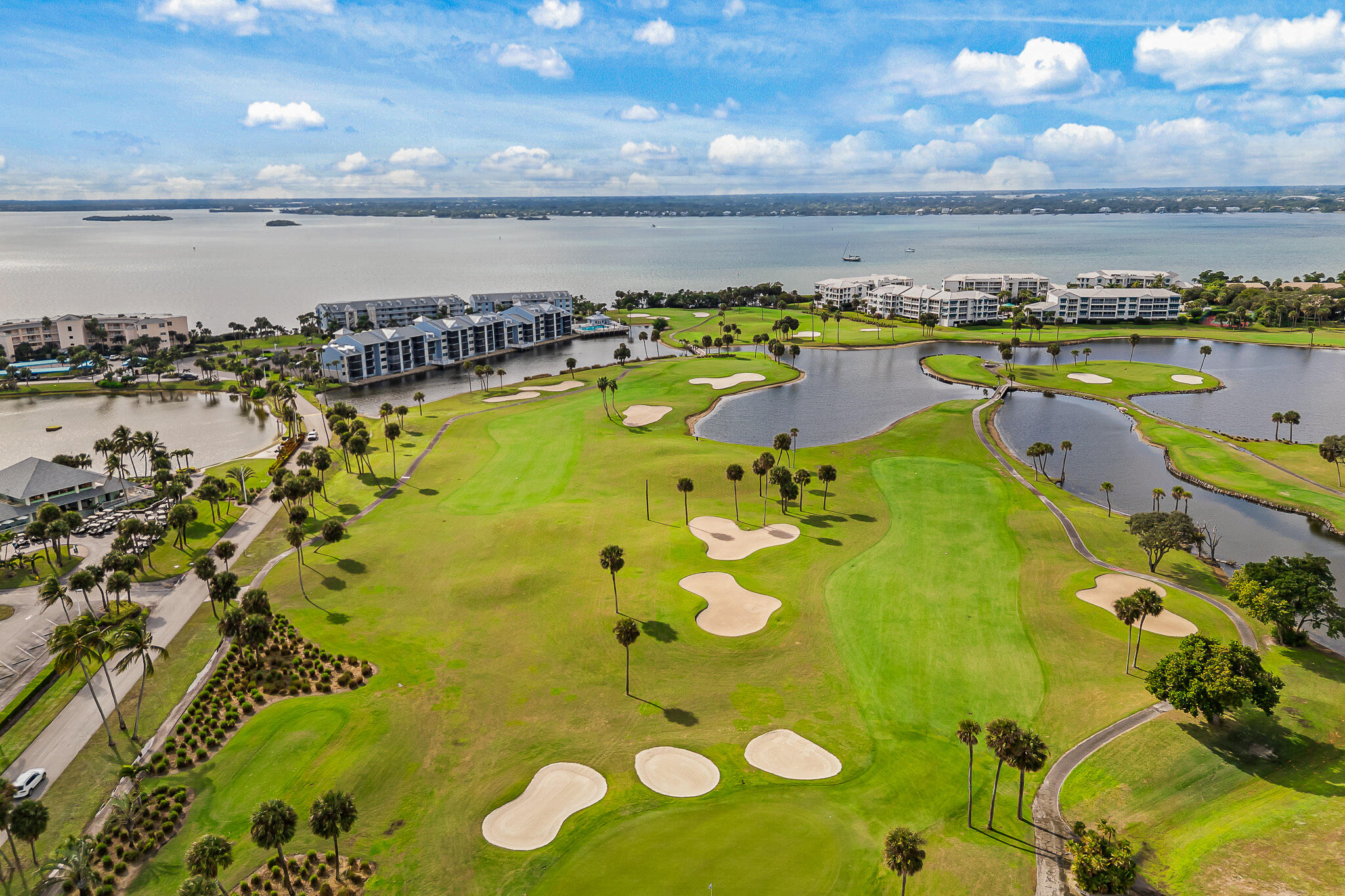 10 Northeast Plantation Road, Unit 305 Jensen Beach, FL 34957 - Photo 43 of 48 a view of a swimming pool with outdoor seating and yard